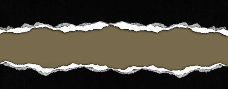 Ripped black paper on brown backgroundの写真素材