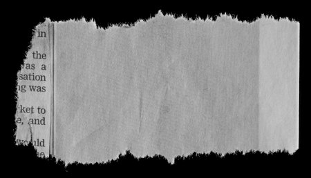 Piece of torn paper on blackの写真素材