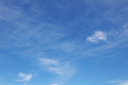 Fluffy white clouds in a blue skyの写真素材