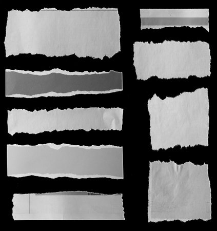 Nine pieces of torn newspaper on black backgroundの写真素材