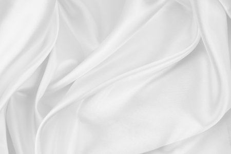 Rippled white silk fabric texture backgroundの写真素材