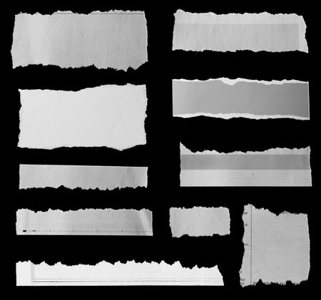Ten pieces of torn newspaper on black backgroundの写真素材