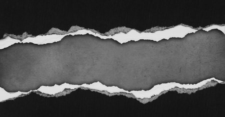 Ripped black paper on grey backgroundの写真素材