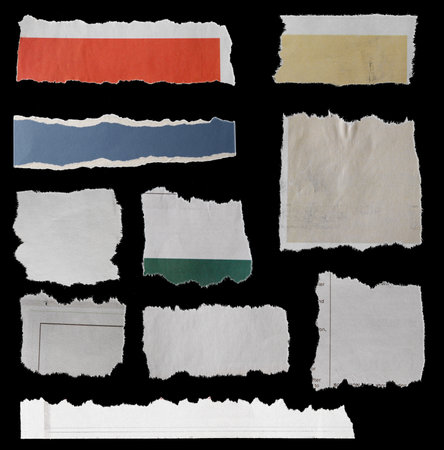 Ten pieces of torn newspaper on black backgroundの写真素材