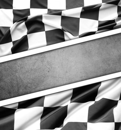Checkered black and white flag on grey background. Copy spaceの写真素材