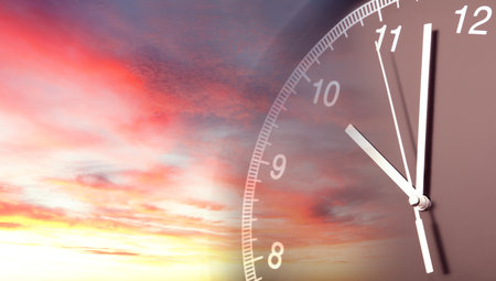 Clock face in bright sky. Time passingの写真素材