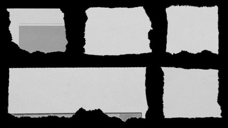 Five pieces of torn newspaper on black backgroundの写真素材