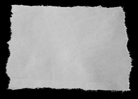 Piece of torn paper on blackの写真素材