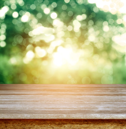Empty table in front of blurred spring lightの写真素材