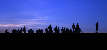 GROUP OF YOUNG PEOPLE SURVIVES THE SUNSETの写真素材