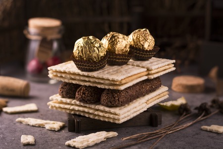 A stack of coconut and chocolate cookies on plain background.のeditorial素材