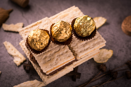 A stack of coconut and chocolate cookies on plain background.