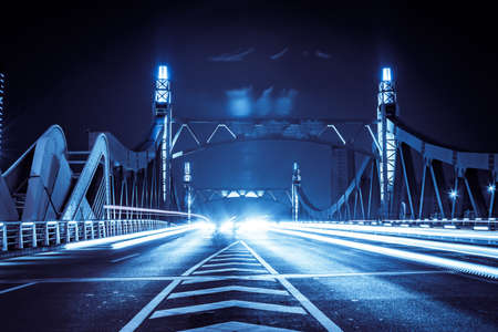 highway bridge at night with traces of light trafficの写真素材