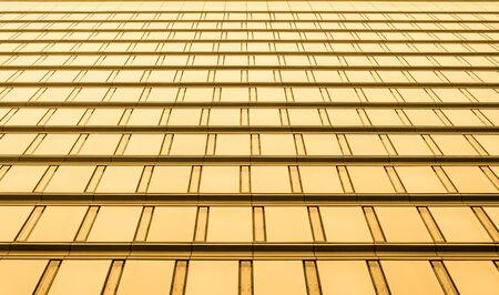 Bottom view of modern skyscrapers in business district in evening light at sunset with lens flare filter effectの写真素材