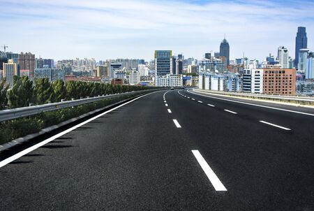 Asphalt road and modern cityのeditorial素材