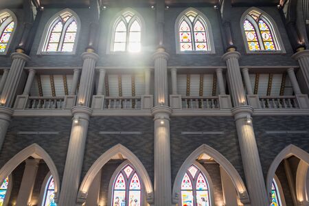 Arched columns in monastery chapel with stained glass windowsのeditorial素材