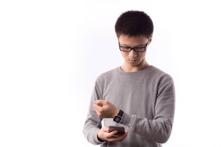 Man with Mobile phone connected to a smart watchのeditorial素材