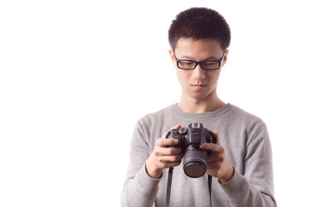 Young man with camera. Isolated over white background.のeditorial素材