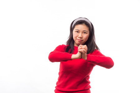 Young chinese girl with hand gesture wishing you good luckの写真素材