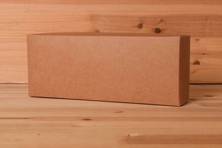 Cardboard box on wooden background