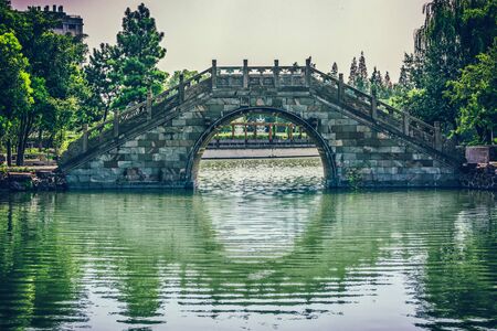Old bridge in Chinese parkの写真素材