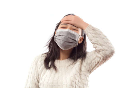 Sick woman with mask on faceの写真素材
