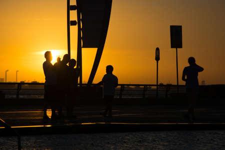 Sunset on the city square and couples.の写真素材