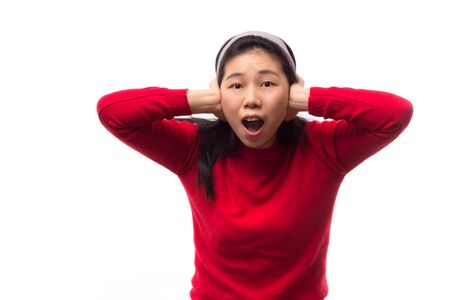 Woman covering her ears isolated on white.の写真素材