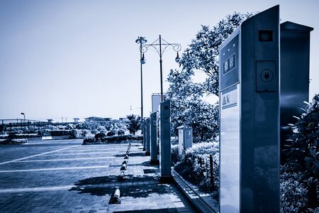 Solar powered electric vehicle car charging station in a public parking lot in California.