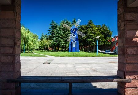 Popular city park Wallanlagen with Am Wall Windmill and colorful flowers foreground in Bremen, Germanyの写真素材