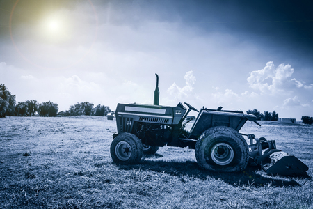 agricultural work plowing land on a powerful tractorの写真素材