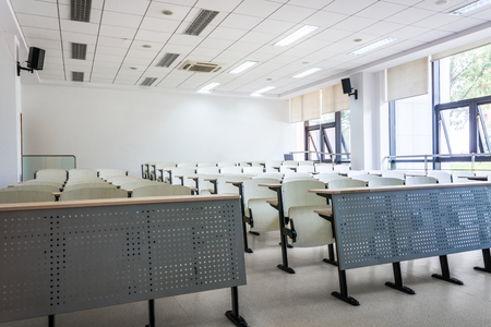 Empty classroom with chairs, desks and chalkboard.のeditorial素材