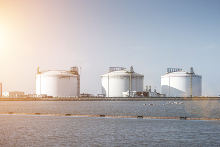 Liquefied natural gas LNG receiving station terminal unloading arm pipe storage tank blue sky and white clouds atmosphere imageのeditorial素材