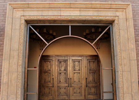 Archway leading to a giant wooden door is the entrace to this beautiful churchの写真素材