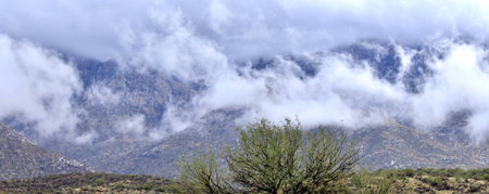 Low hanging cwinter clouds span across an Arizona mountain range,の写真素材