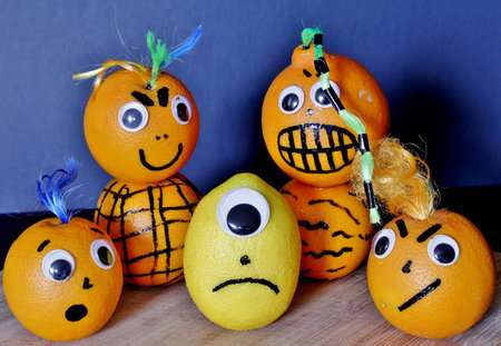 Angry Gang of Oranges Giving the Squeeze to this Sour Lemon.の写真素材