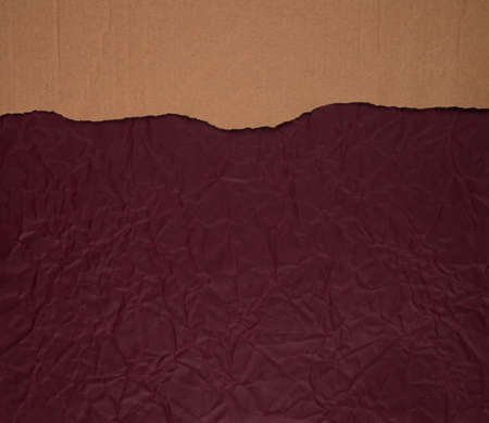 Cardboard torn edge on handmade paper backgroundの写真素材