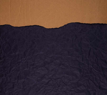 Cardboard torn edge on handmade paper backgroundの写真素材