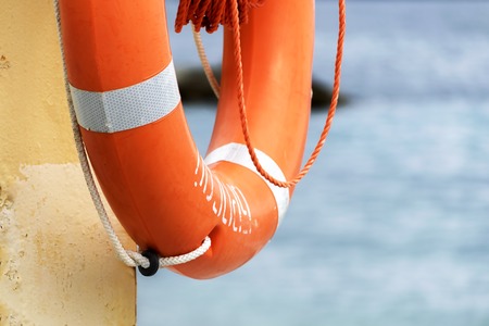 lifebuoy on the seashore near the waterの写真素材