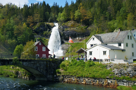 Norwegian landscape with houses and waterfallの写真素材