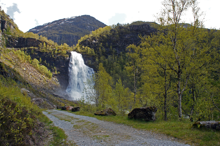 The road to Fossen Bratte in Samnanger, Hordaland, Norway surrounded by mountainsの写真素材
