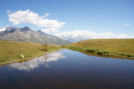 Mountain lakes reflecting tops of Ushba in Mestia, Georgiaの写真素材