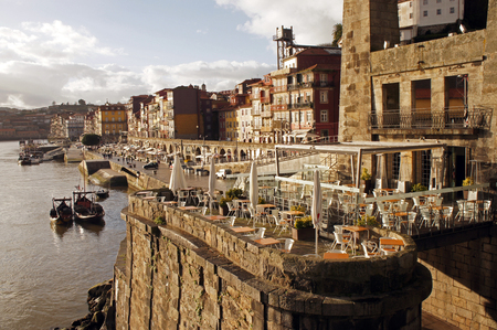 Bars and restaurants next to the Ponte Dom Lu?s I (King Luis I Bridge) over the Duoro river constructed by Gustave Eiffel group in Porto, Portugalの写真素材