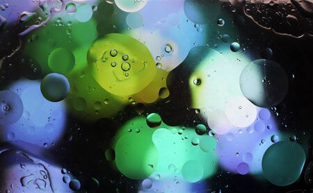 abstract photo. Water and oil on the glass. Abstract colorful pattern liquid textured background. Macro photography. Blue and green colors. Blurred background.の写真素材