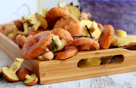 Fresh raw mushrooms . Autumn mushrooms on a wooden rustic table. Forest mushrooms on a wooden trayの写真素材