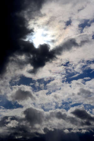 Beautiful dramatic sky with sun rays. Dark clouds and breaking through the sun's rays ,. Vertical formatの写真素材