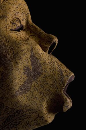 Wooden mask given profile on black の写真素材