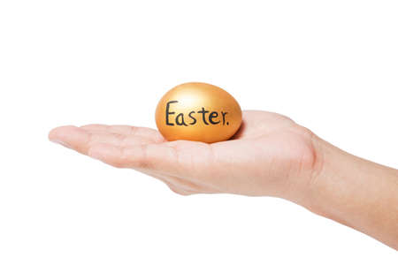 Gold easter egg in hand isolated on white background