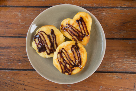 pancakes with chocolate on the plate and wood backgroundの写真素材