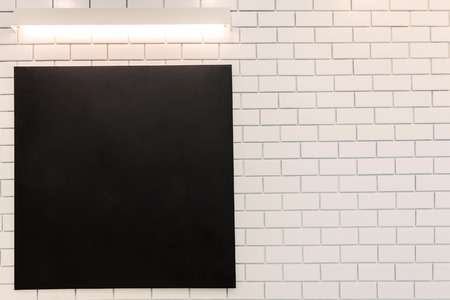 Frame black board with blank area for text or message on wall in cafe with vintage toneの写真素材
